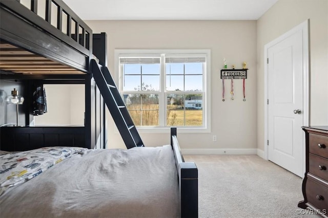 bedroom with baseboards and carpet