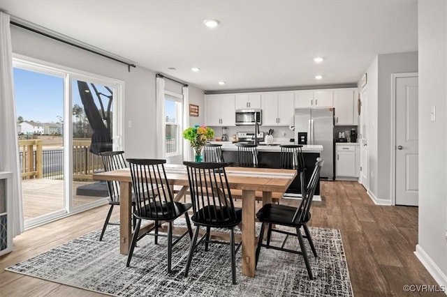 dining area with recessed lighting, wood finished floors, and baseboards