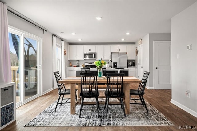 dining room featuring recessed lighting, baseboards, and wood finished floors