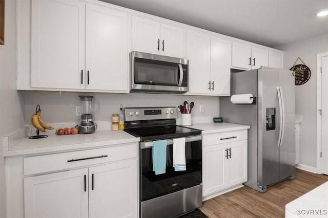 kitchen featuring light countertops, light wood-style flooring, white cabinets, and stainless steel appliances