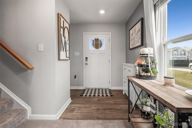 entrance foyer featuring stairs, wood finished floors, and baseboards