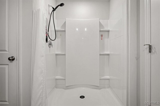 bathroom featuring a shower stall