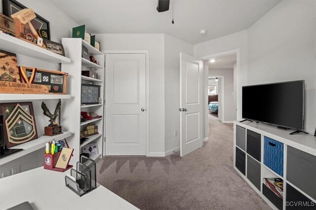 interior space with a ceiling fan and baseboards