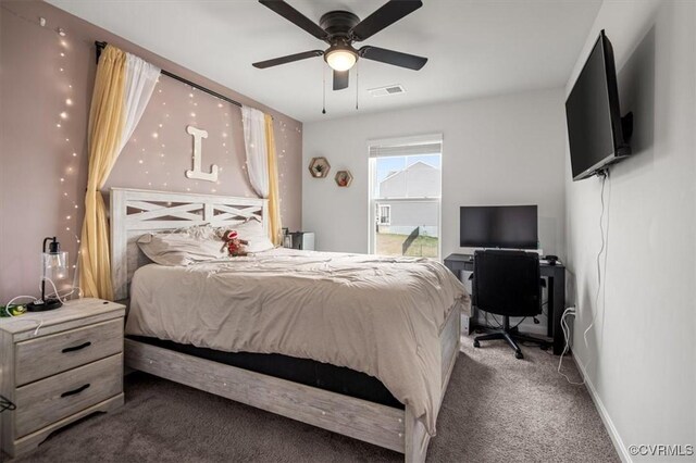 carpeted bedroom with visible vents, a ceiling fan, and baseboards