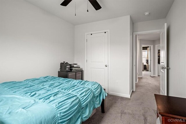 bedroom with ceiling fan, baseboards, and carpet