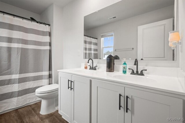 7809 Faisan Ln, New Kent, VA 23124 - full bath with wood finished floors, toilet, and double vanity