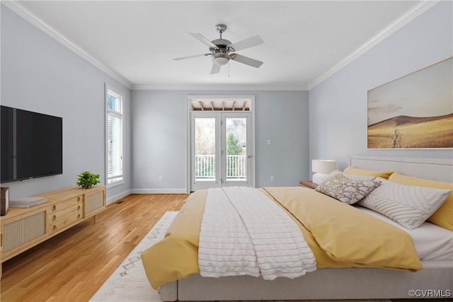 bedroom with multiple windows, wood finished floors, ornamental molding, and access to outside