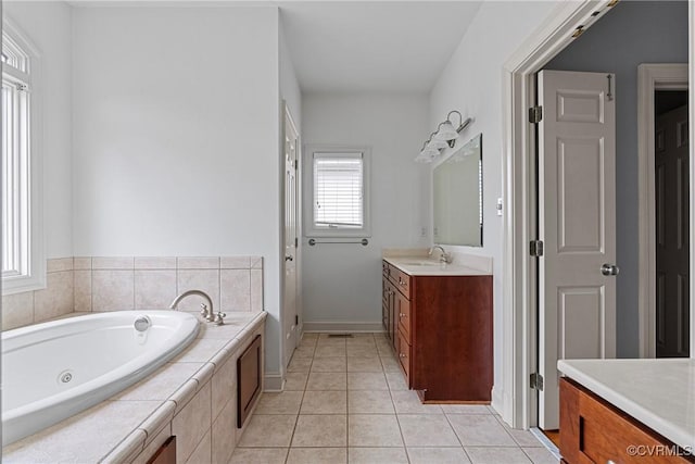 full bathroom featuring tile patterned floors, baseboards, vanity, and a whirlpool tub