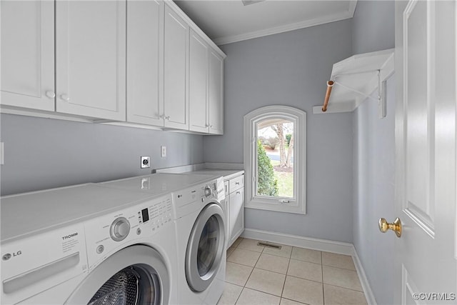 clothes washing area with light tile patterned floors, visible vents, cabinet space, crown molding, and washer and clothes dryer