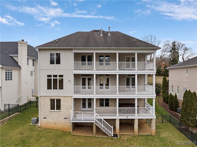 back of house with central AC, a yard, a fenced backyard, crawl space, and a balcony