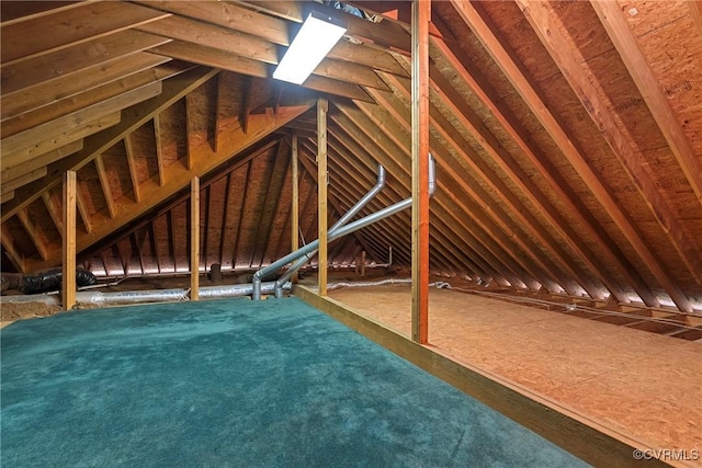 unfinished attic featuring an upstairs landing