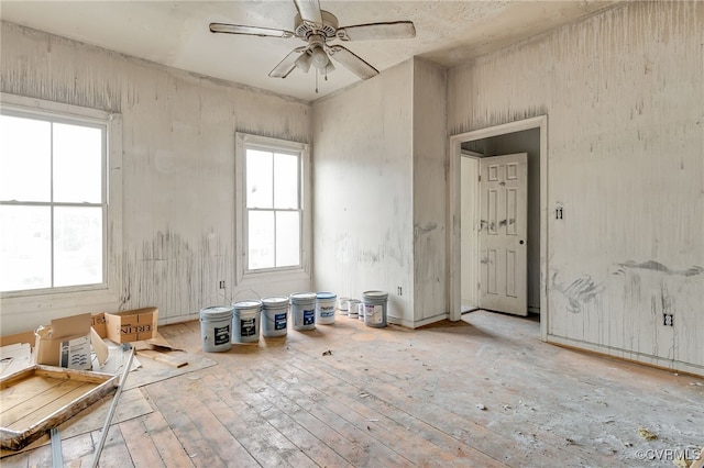 unfurnished room featuring a ceiling fan and wood-type flooring