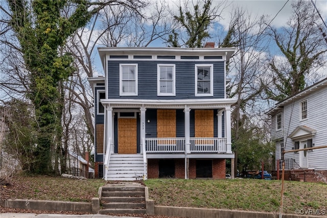 italianate house featuring stairs, a porch, and a chimney