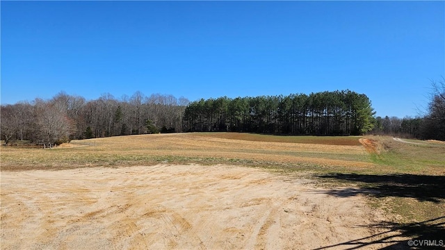 view of landscape featuring a rural view and a view of trees