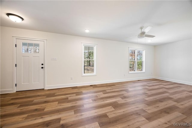 foyer entrance featuring wood finished floors and baseboards