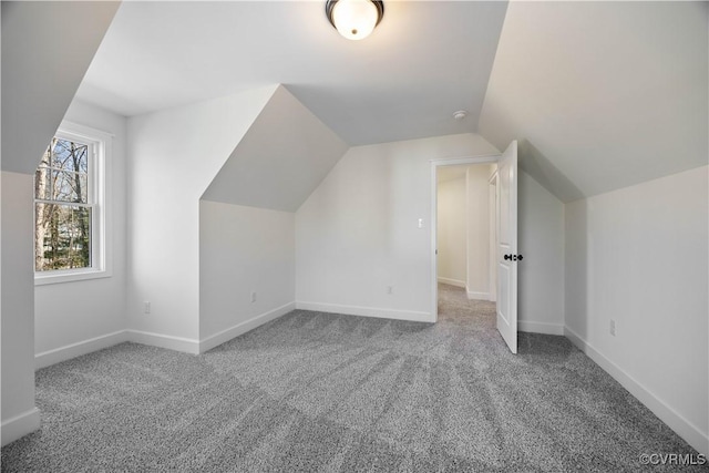 additional living space with lofted ceiling, carpet flooring, and baseboards