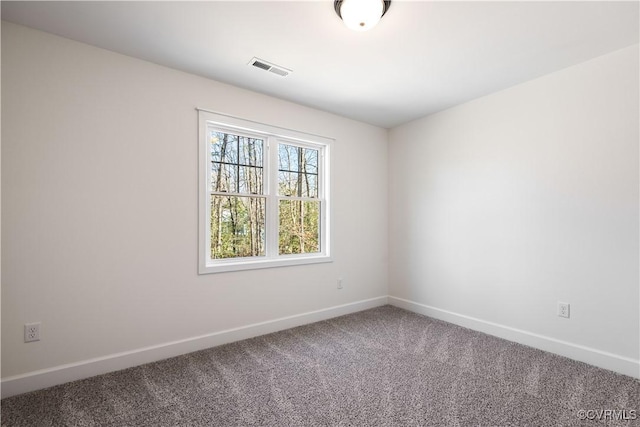 unfurnished room with visible vents, baseboards, and carpet floors