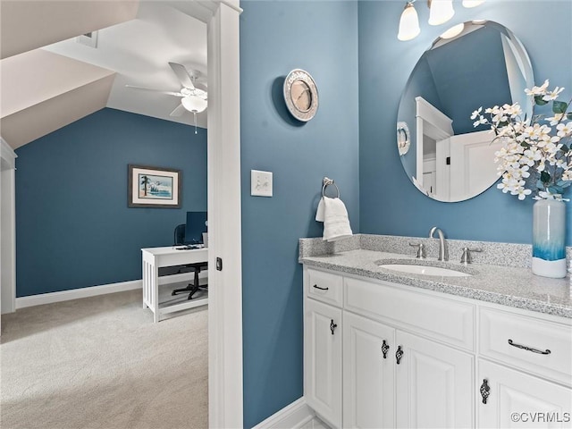 bathroom featuring vanity, lofted ceiling, baseboards, and ceiling fan