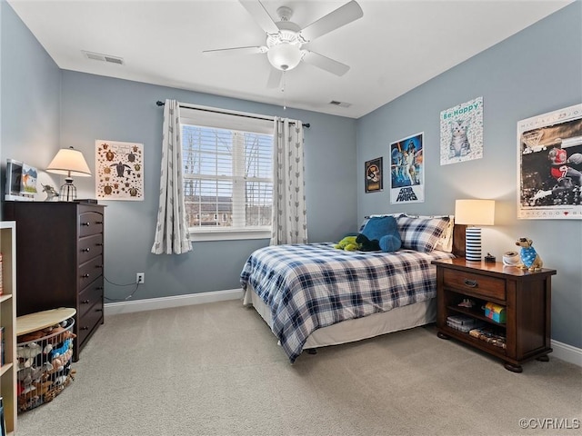 carpeted bedroom featuring visible vents, baseboards, and a ceiling fan