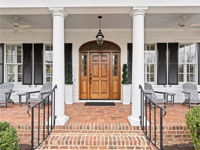 entrance to property featuring a porch and ceiling fan