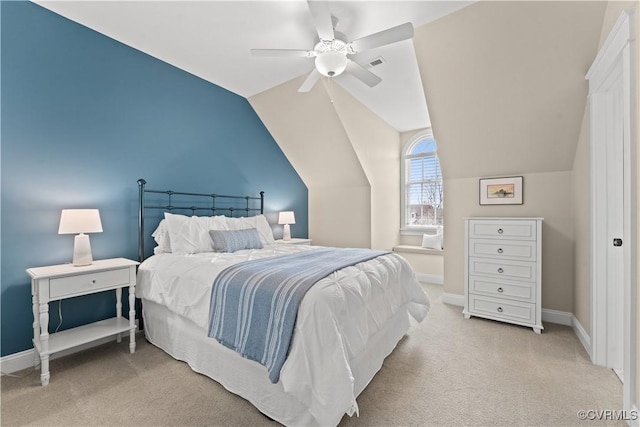 bedroom featuring visible vents, light colored carpet, baseboards, and vaulted ceiling