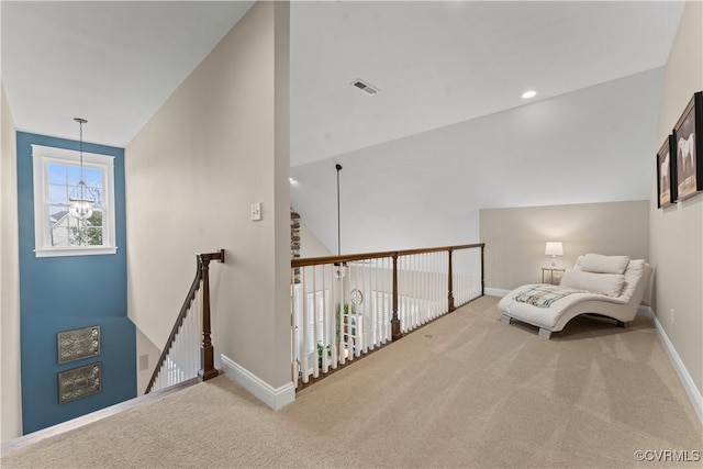 living area with visible vents, baseboards, vaulted ceiling, carpet flooring, and an upstairs landing