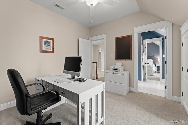 office featuring visible vents, baseboards, light colored carpet, lofted ceiling, and a ceiling fan