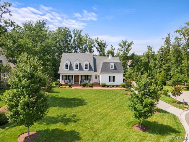 view of front of house with covered porch and a front lawn