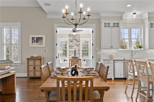 dining room with a wealth of natural light, ornamental molding, and light wood finished floors