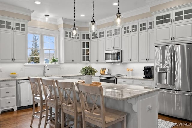 kitchen featuring white cabinetry, crown molding, and stainless steel appliances