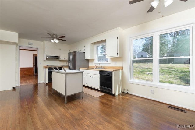 kitchen featuring visible vents, under cabinet range hood, dishwasher, stainless steel refrigerator with ice dispenser, and white cabinets