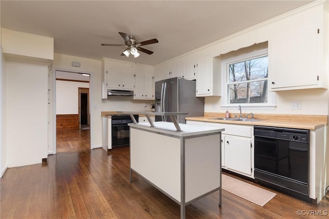 kitchen featuring stainless steel fridge with ice dispenser, black dishwasher, range, white cabinets, and a sink