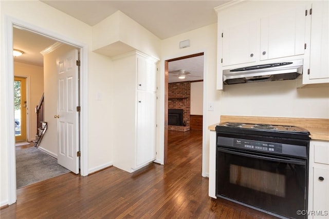 kitchen with black range with electric stovetop, ornamental molding, under cabinet range hood, dark wood finished floors, and white cabinetry