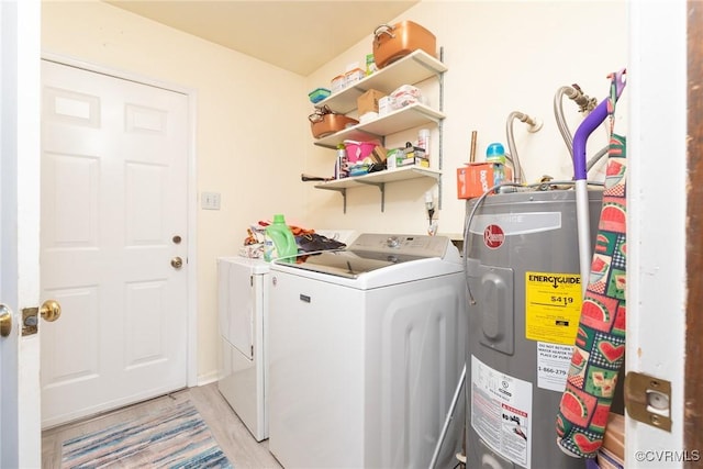 laundry area featuring water heater, laundry area, and washer and clothes dryer