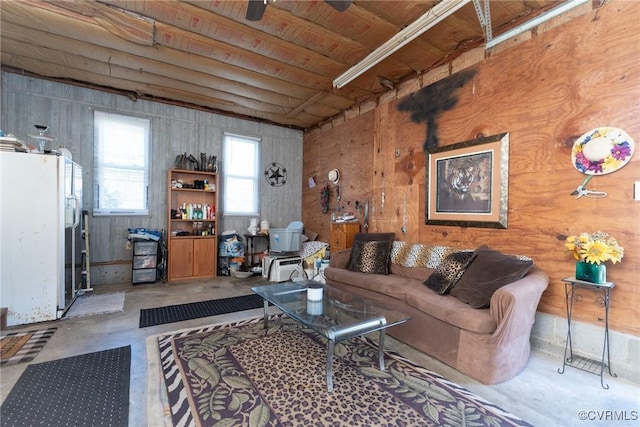 living area featuring unfinished concrete flooring