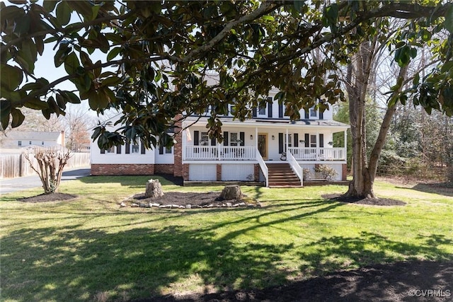 view of front of home with stairway, a porch, and a front lawn