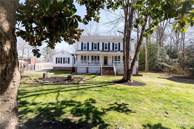 view of front of house with a porch, fence, and a front yard