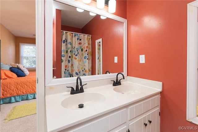 ensuite bathroom with double vanity, ensuite bathroom, and a sink