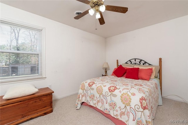 carpeted bedroom featuring visible vents, baseboards, and a ceiling fan