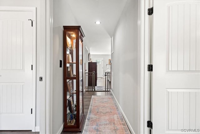 hallway featuring recessed lighting, baseboards, and wood finished floors