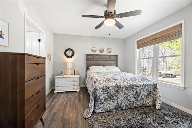 bedroom featuring dark wood finished floors, baseboards, and ceiling fan