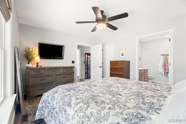 bedroom with dark wood finished floors, ceiling fan, and connected bathroom