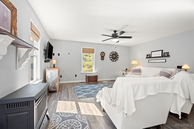 bedroom with wood finished floors, baseboards, and ceiling fan