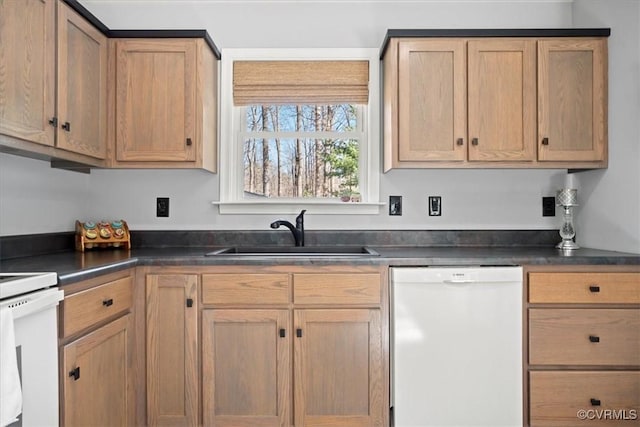 kitchen with a sink, range, dark countertops, and white dishwasher