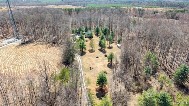 bird's eye view with a wooded view