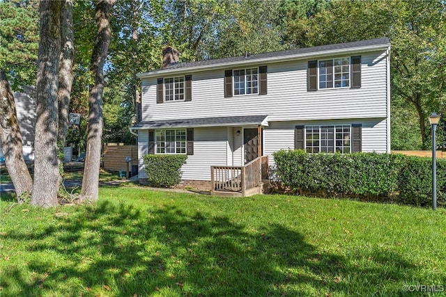 view of front of home with a front lawn and a chimney