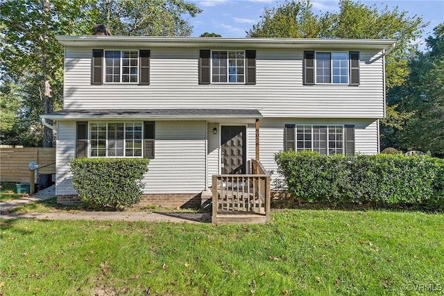 view of front of home featuring a front lawn and fence