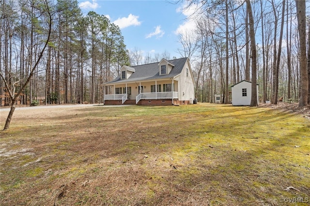 view of front of property featuring crawl space, covered porch, an outdoor structure, and a front lawn