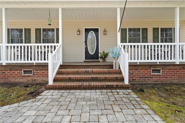 property entrance featuring covered porch