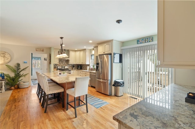 dining space with light wood finished floors and recessed lighting